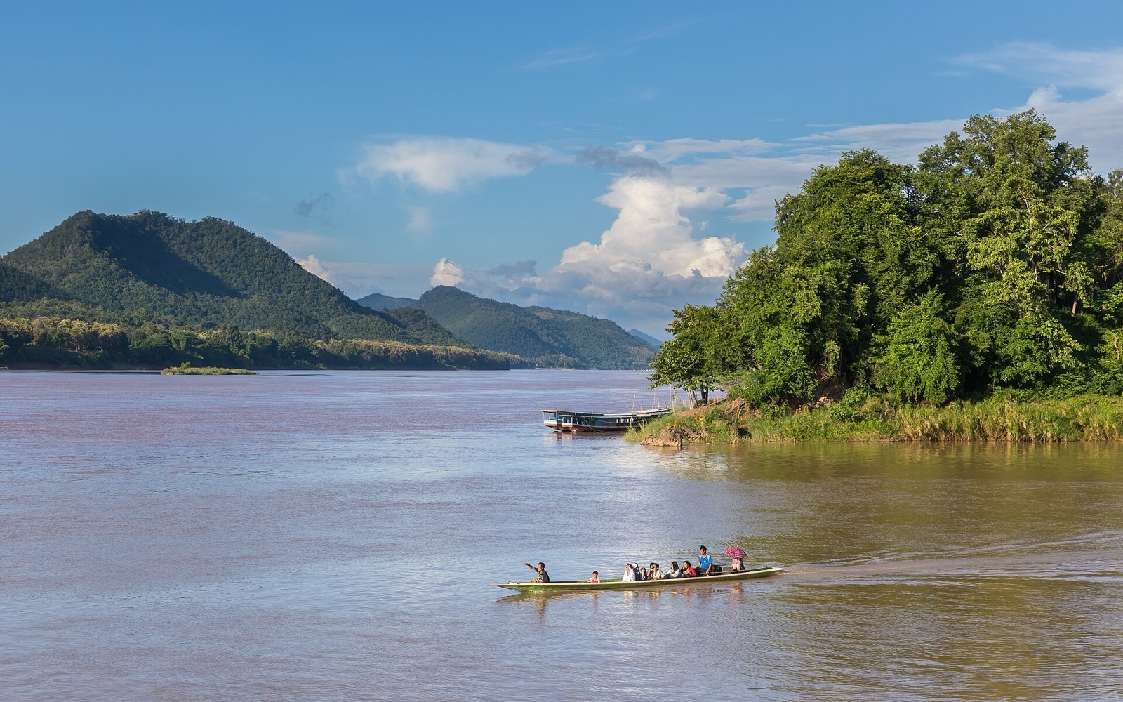 A long boat with a boatman on the Mekong at the Nam Khan mouth, Luang Prabang