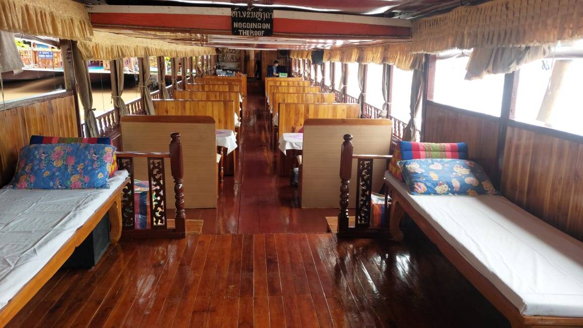 Wooden berths inside a Mekong slow-boat cabin
